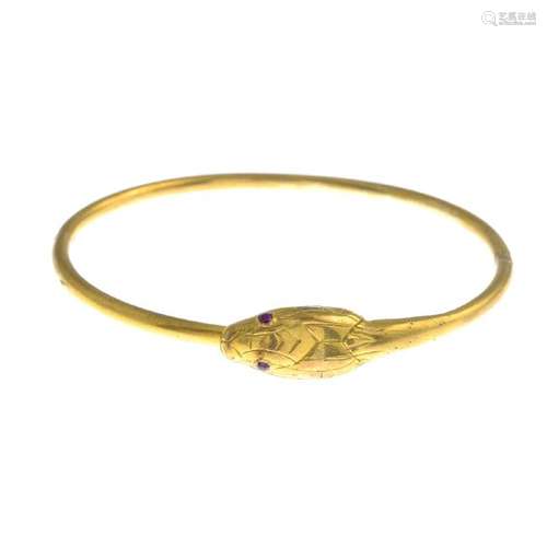 A late Victorian gold hinged snake bangle. Designed as