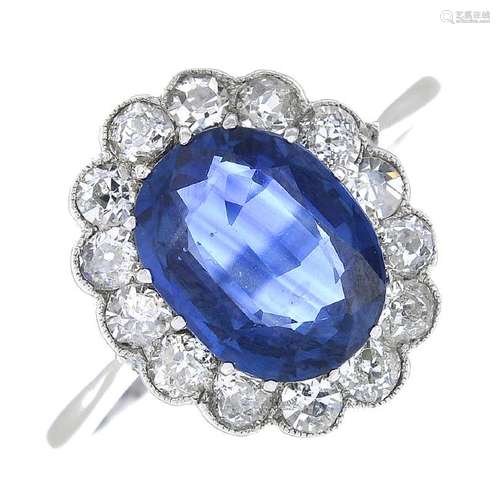 A sapphire and diamond floral cluster ring. The