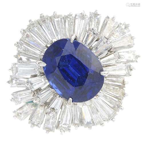 A sapphire and diamond cluster ring. The oval-shape