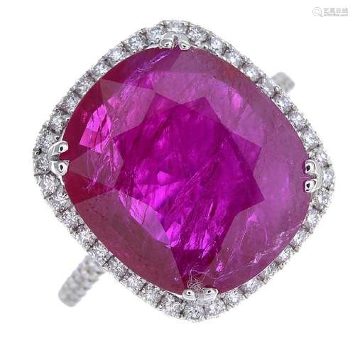 A ruby and diamond cluster ring. The oval-shape ruby,