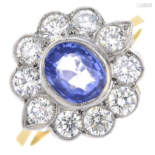 A sapphire and diamond cluster ring. The oval-shape