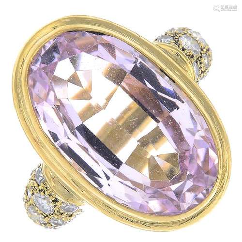 A topaz and diamond ring. The oval-shape pink topaz