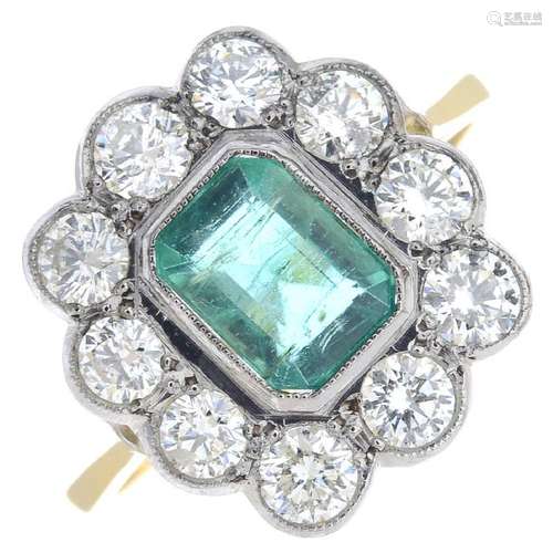 An 18ct gold emerald and diamond cluster ring. The