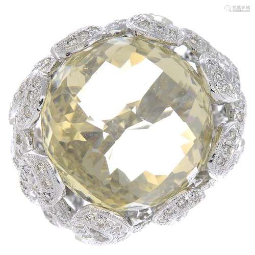 A citrine and diamond dress ring. The circular-shape