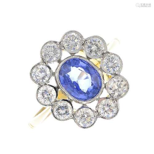 A sapphire and diamond cluster ring. The oval-shape