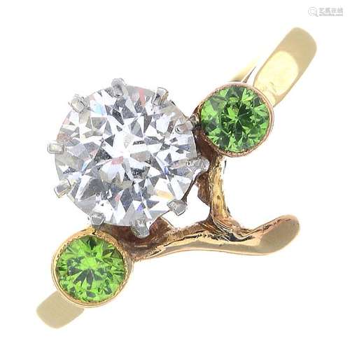 A diamond and demantoid garnet floral dress ring. The