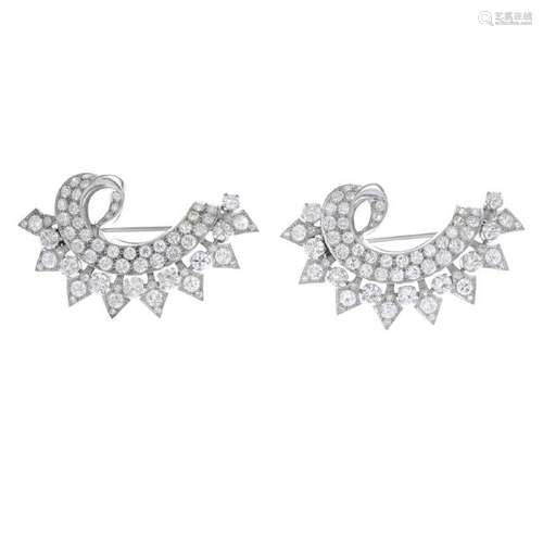 A pair of diamond brooches. Each designed as a pave-set