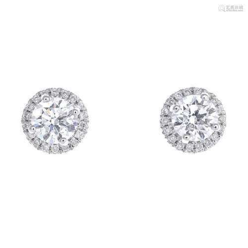 A pair of diamond stud earrings. Each designed as a