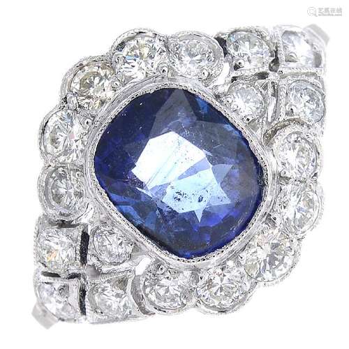 A sapphire and diamond ring. The cushion-shape