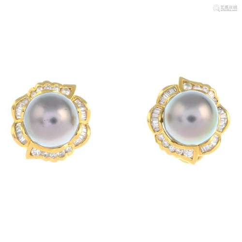 A pair of cultured pearl and diamond earrings. Each