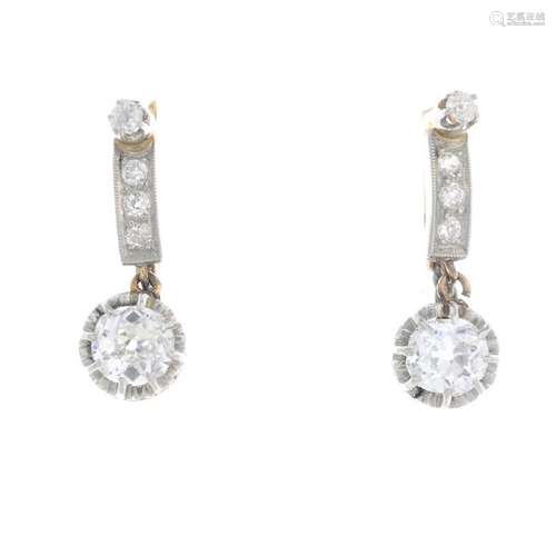 A pair of diamond earrings. Each designed as an old-cut