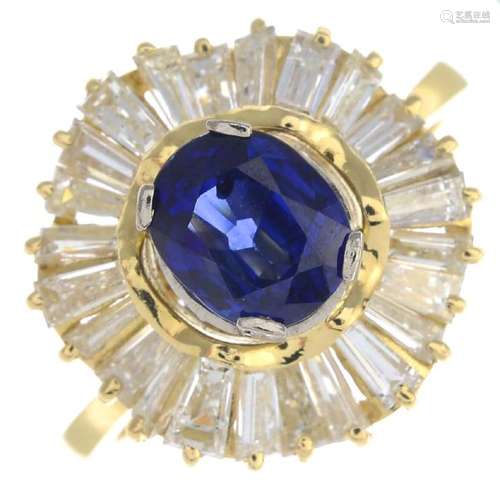 A sapphire and diamond cluster ring. The oval-shape