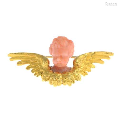 A late Victorian gold coral brooch. Carved to depict a