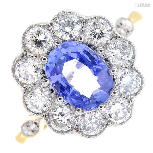 A sapphire and diamond cluster ring. The oval-shape