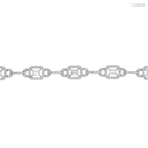 An 18ct gold diamond bracelet. Of openwork design, the