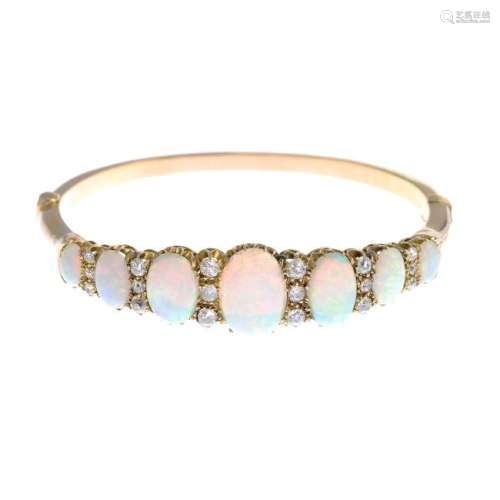 A late Victorian 18ct gold opal and diamond bangle. The