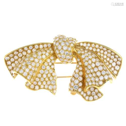 A diamond brooch. Designed as a pave-set diamond bow.