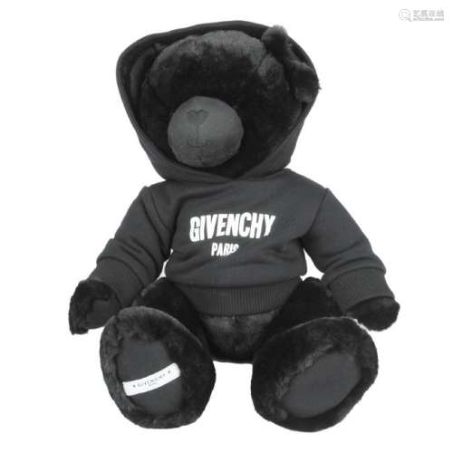 GIVENCHY - a black Logo Teddy Bear. Wearing a hoodie