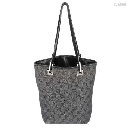 GUCCI - a mini bucket handbag. Designed with an open