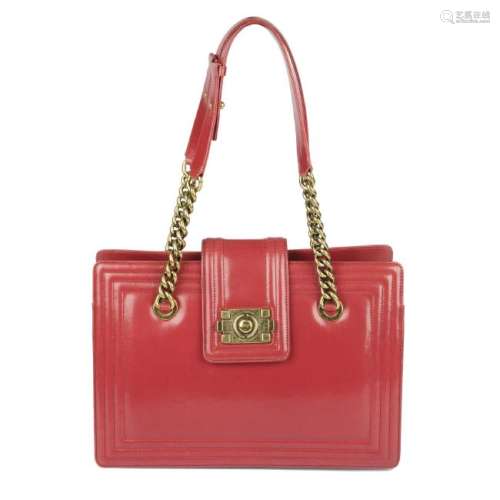 CHANEL - a red Small Boy Tote. Designed with a smooth