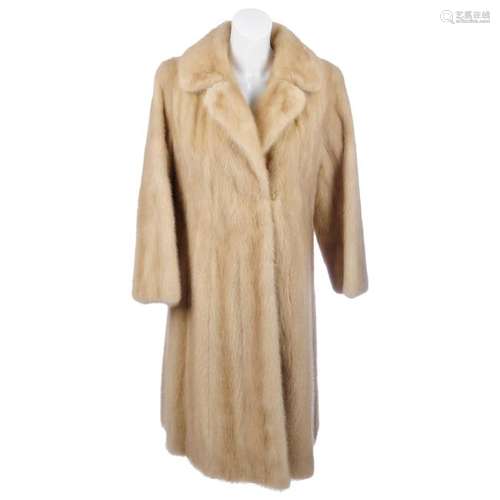 A knee-length palomino mink coat. Designed with a