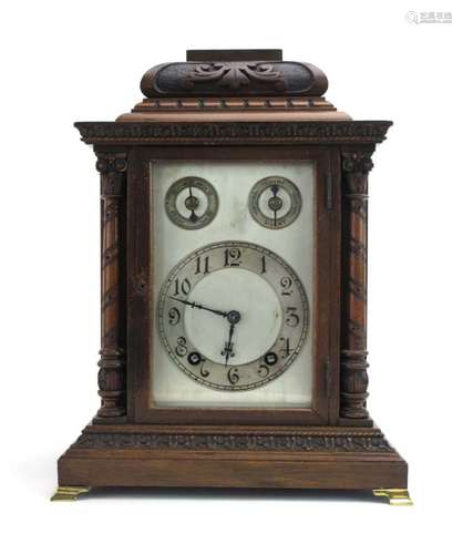 A German bracket clock, the silvered face with secondary dials and Arabic numerals,