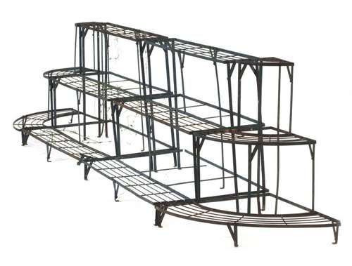 A set of metalwork garden plant stands including two three-tier sections and a pair of corner ends