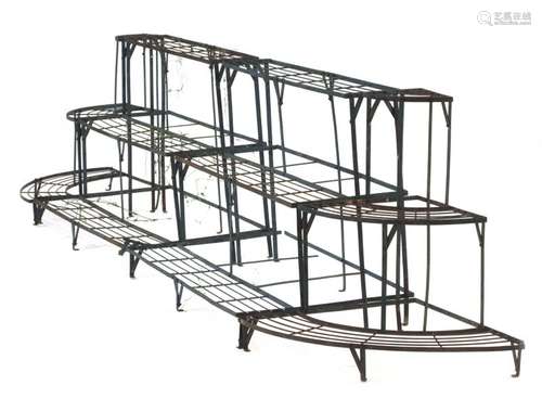 A set of metalwork garden plant stands including two three-tier sections and a pair of corner ends