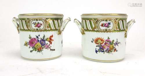 A pair of Dresden two handled cylindrical jars, typically decorated with floral sprays, h.