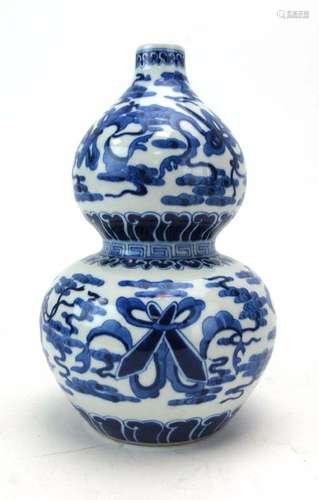 A Chinese blue and white double gourd vase decorated with baskets of flowers,