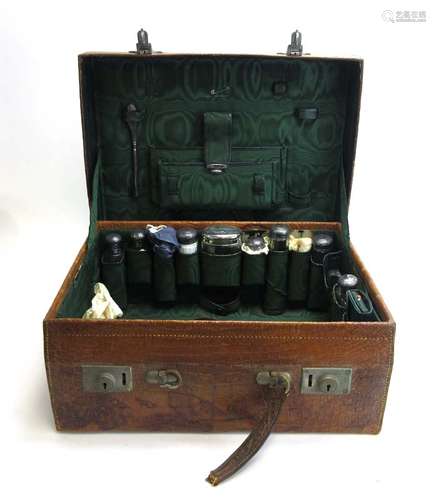 An Edwardian faux crocodile skin travelling case with green watered silk interior fitted with