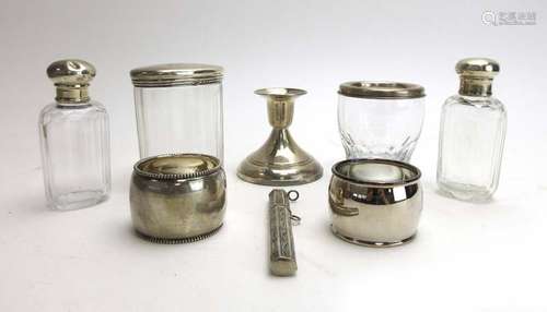 A mixed parcel of silver and metalware comprising a dwarf candlestick, two napkin rings,