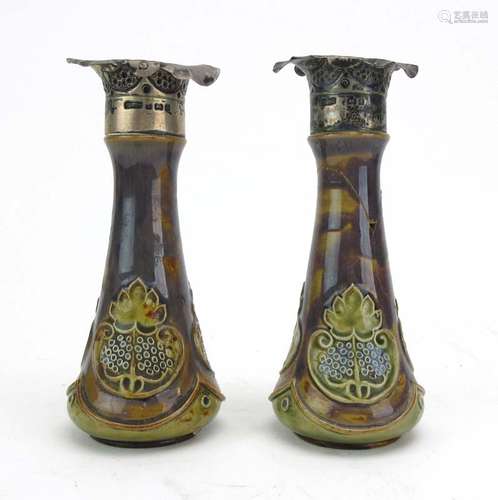 A pair of Royal Doulton silver mounted bottle vases decorated with foliate motifs on a mottled