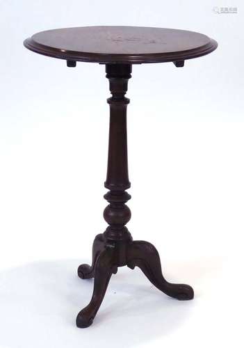 A 19th century marquetry wine table, the tilt-top on a turned column and tripod base, d.