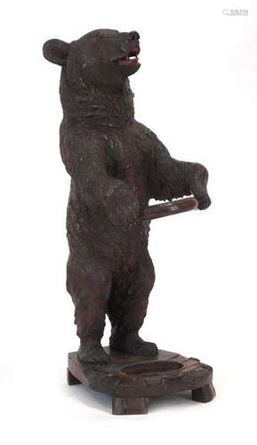 An early 20th century 'Black Forest' carved umbrella and stick stand modelled as a bear with a