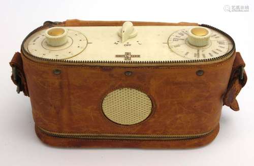 A portable RR Roberts Radio in a tan leather fitted case