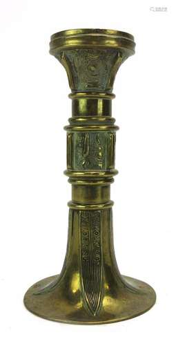 A Chinese brass candlestick of flared form, h.