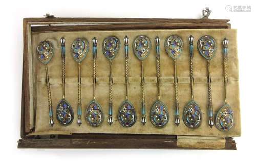 A cased set of twelve early 20th century Russian silver gilt spoons decorated in cloisonne enamel