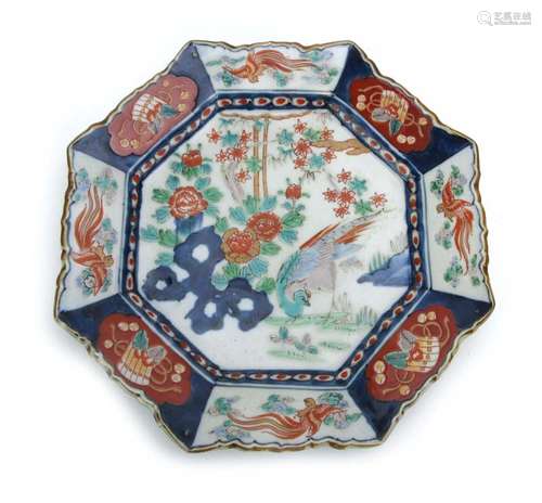 An Imari charger of octagonal form decorated with an exotic bird within a blossoming landscape, w.