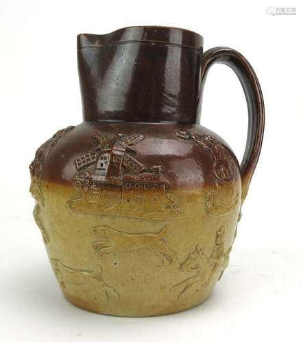 A salt glazed stoneware water jug in the manner of Doulton, relief decorated with a hunting scene,