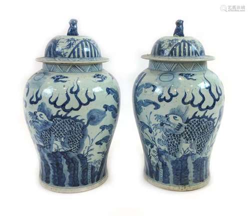 A pair of Chinese blue and white ginger jars and covers of shouldered form decorated with dragons