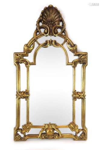 A 20th century wall mirror with a moulded gilt frame and shell pediment,