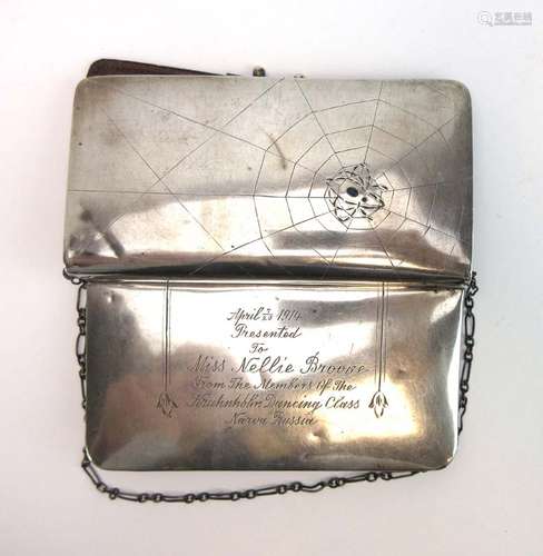 An early 20th century Russian silver purse decorated with a spider in its web,