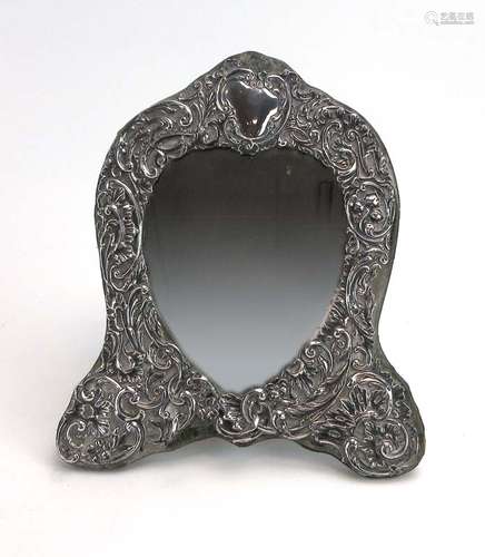 An early 20th century silver mounted and repousse decorated easel back table mirror of arched form,