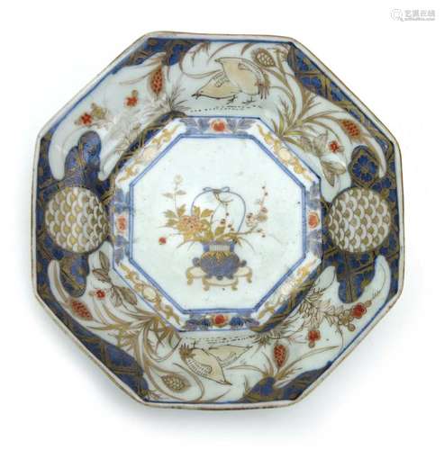 An 18th century Japanese Imari plate of octagonal form, centrally decorated with a vase of flowers,