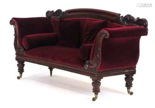 A 19th century and later mahogany sofa of Rococo form on turned legs with castors