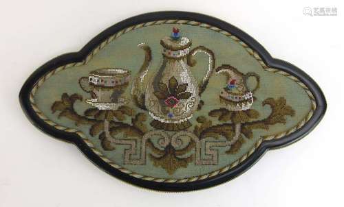 An Edwardian ebonised and gilt metal mounted tray with a beadwork surface depicting a teapot and