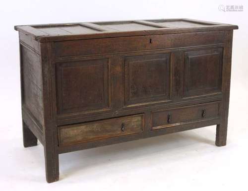 An 18th century oak mule chest, the three panelled front over two drawers,