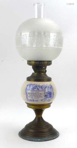 A Duplex brass and ceramic oil lamp, transfer printed with a toy advert 'Hobby-horses, tops,