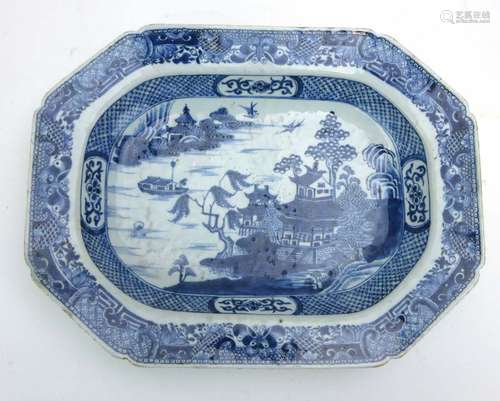 An 18th century Chinese blue and white dish of canted rectangular form decorated in the 'Willow'